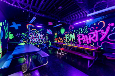 Kids celebrating a colorful birthday party with balloons and cake at AeroSports St Catharines